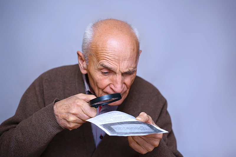 Man having trouble reading